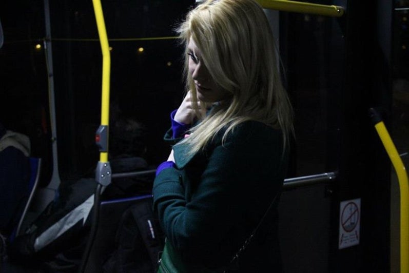 Woman stands on bus