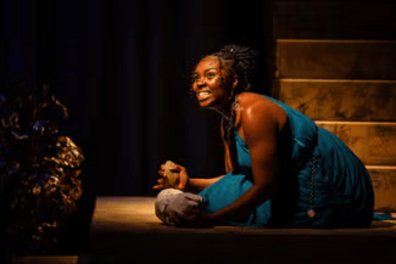 Woman kneeling with a furious expression on her face