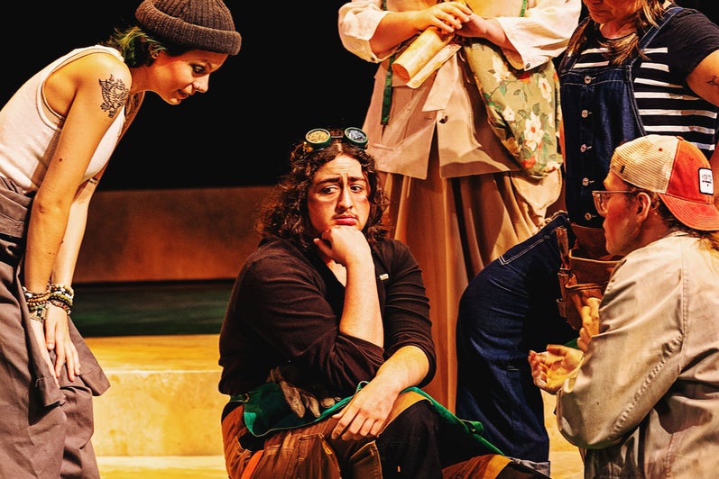 The Mechanicals anxiously cluster around Nick Bottom (Theo Patterson) to persuade him to play the part of Pyramus.