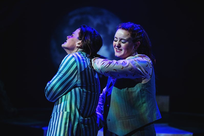 Lysandra (Sarah Kelly) twists the arm of Demetrius (Ethan Warren) in a crime of passion.