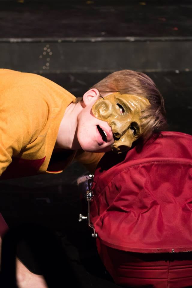 Commedia dell'arte character listens to baby basket