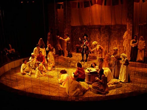 Cast of Marat/Sade performing on stage