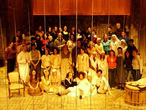 Cast of Marat/Sade posing for a photo on stage