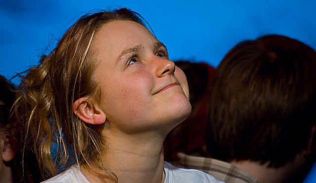 Girl smiling and looking to the sky in the play Differ/End: The Caledonia Project