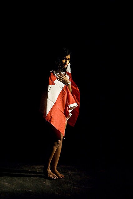 Girl standing draped in a Canadian flag