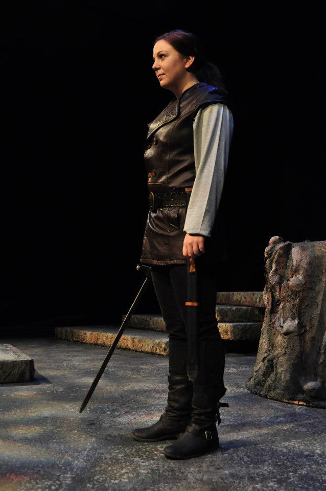 Macbeth stands with sword
