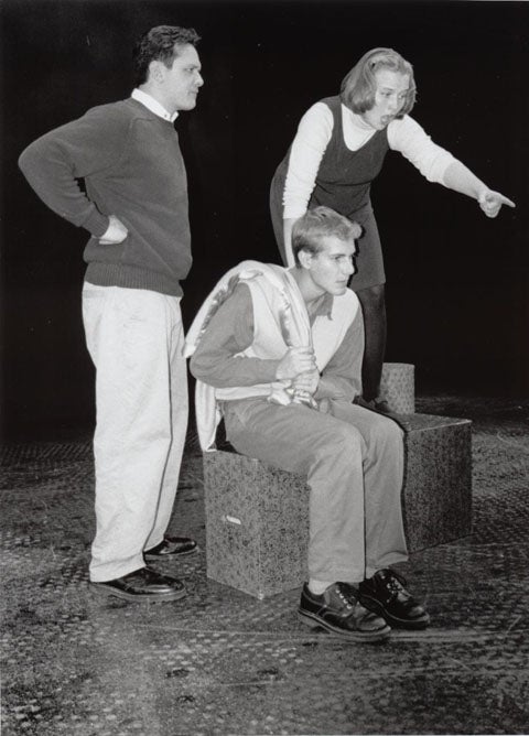 Woman in astonishment pointing out something to two other men