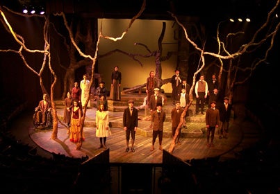 Cast of Spring Awakening standing on stage facing the crowd