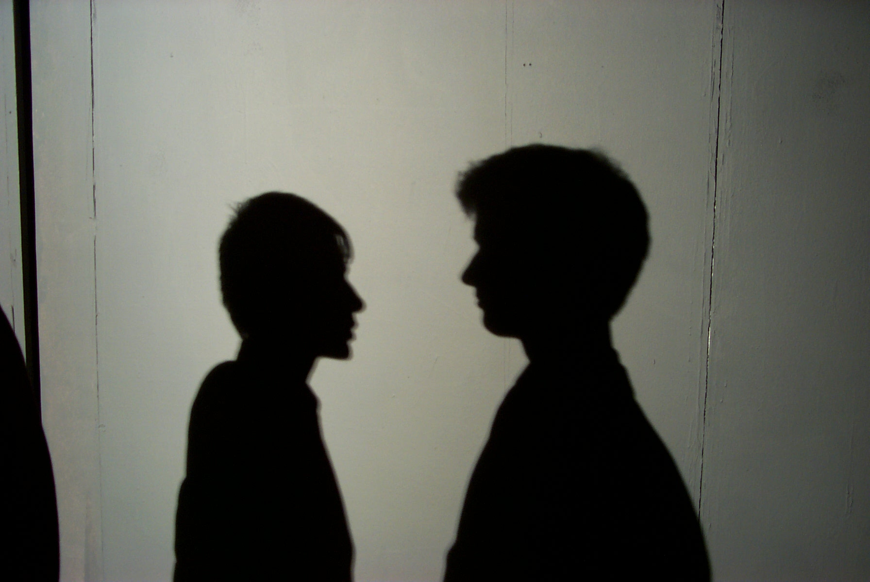 Shadows of two men facing each other