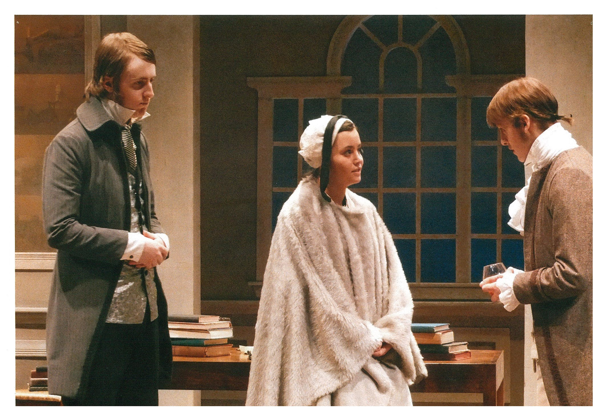 A man in grey coat, one man in a brown coat and a woman in a white cloak
