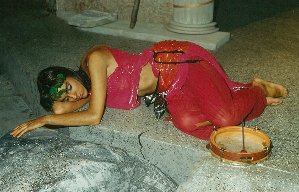 Woman in red outfit laying on the ground asleep