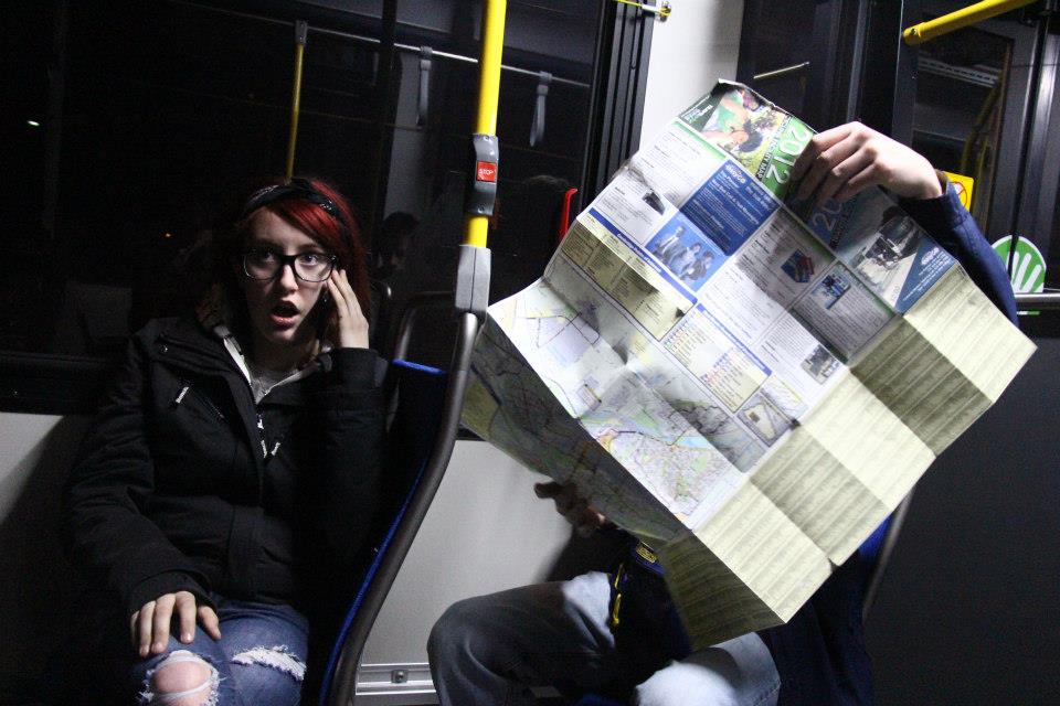 Woman talks on phone while man looks at map