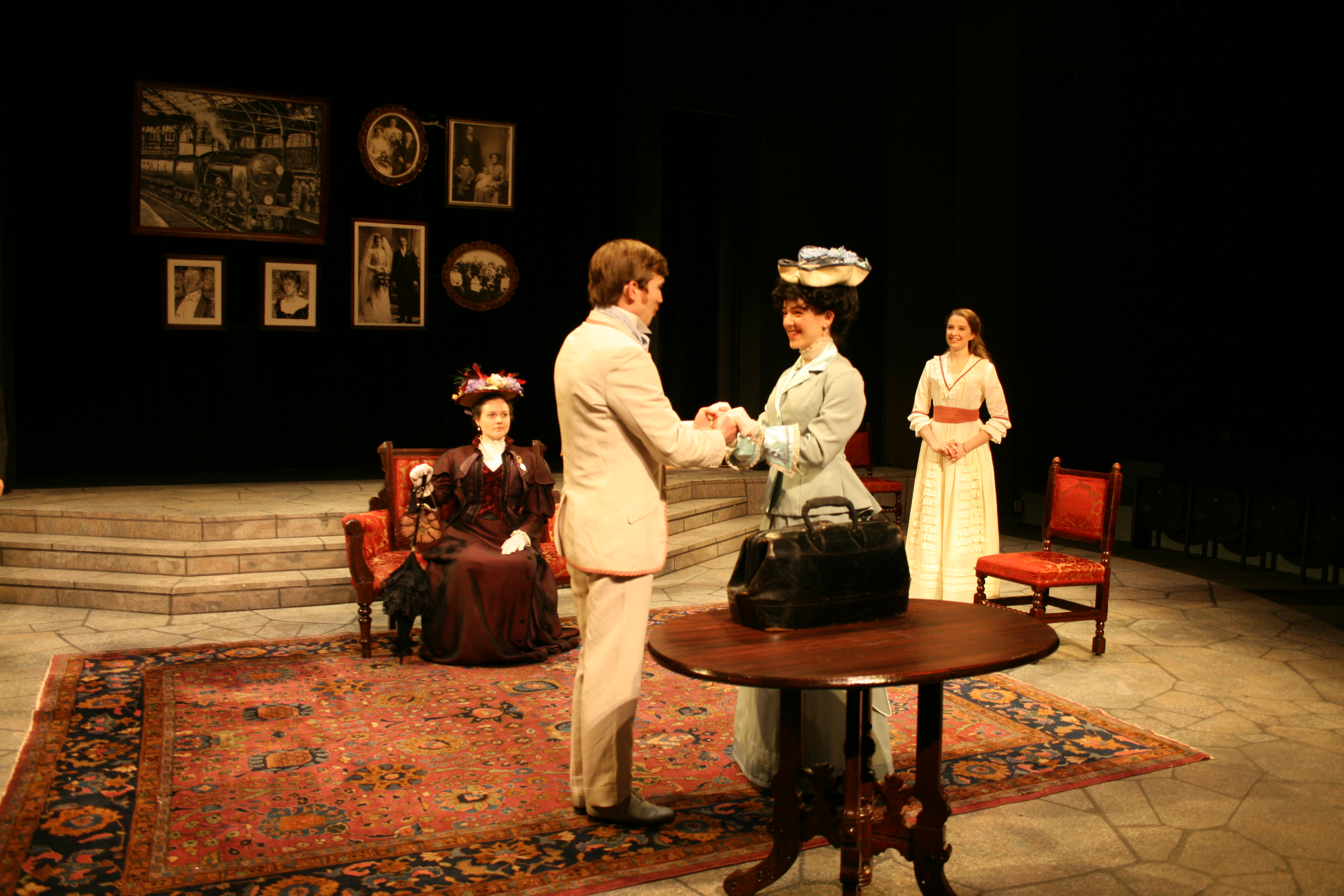 A man and woman hold hands while two women watch from the background