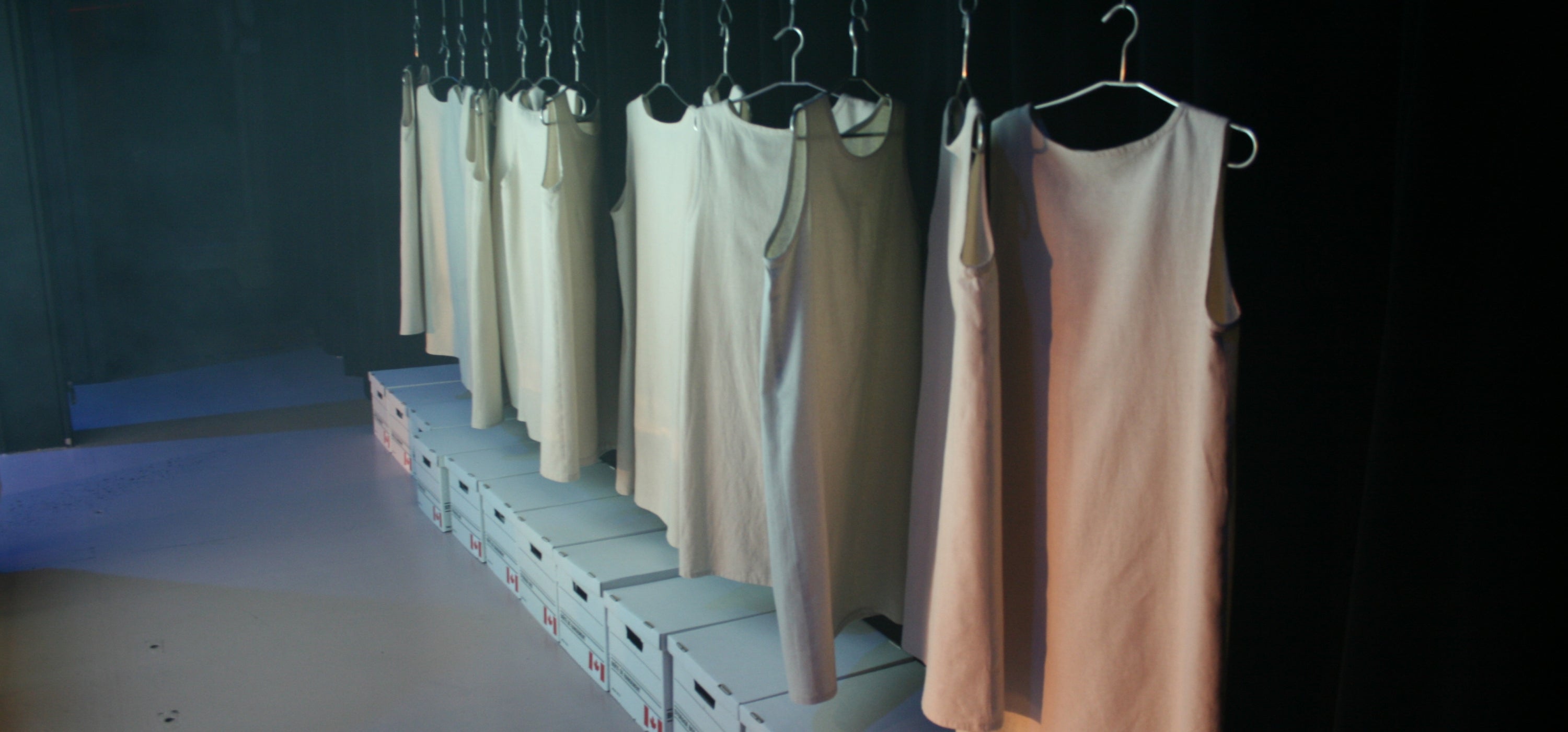 row of white dresses on hangers