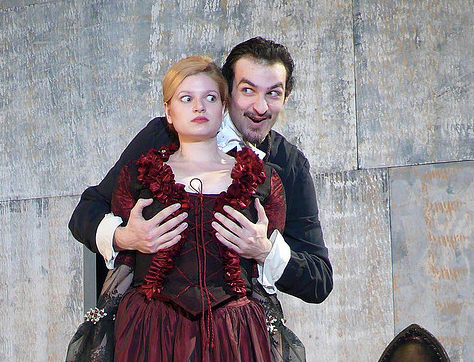 Man cupping a woman's breasts (in costumes) in the play Tartuffe