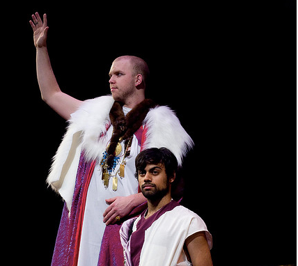 A scene from the play 'Julius Cesar' in which two men are dressed in roman robes with one on his knees