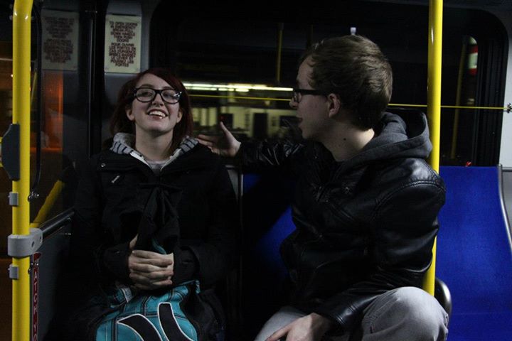 Man and woman talk on bus