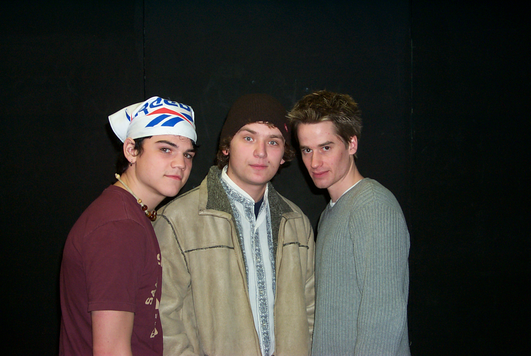 Three men posing for a picture