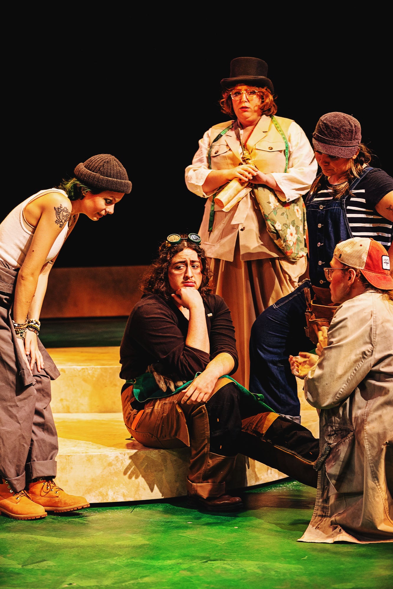 The Mechanicals anxiously cluster around Nick Bottom (Theo Patterson) to persuade him to play the part of Pyramus.