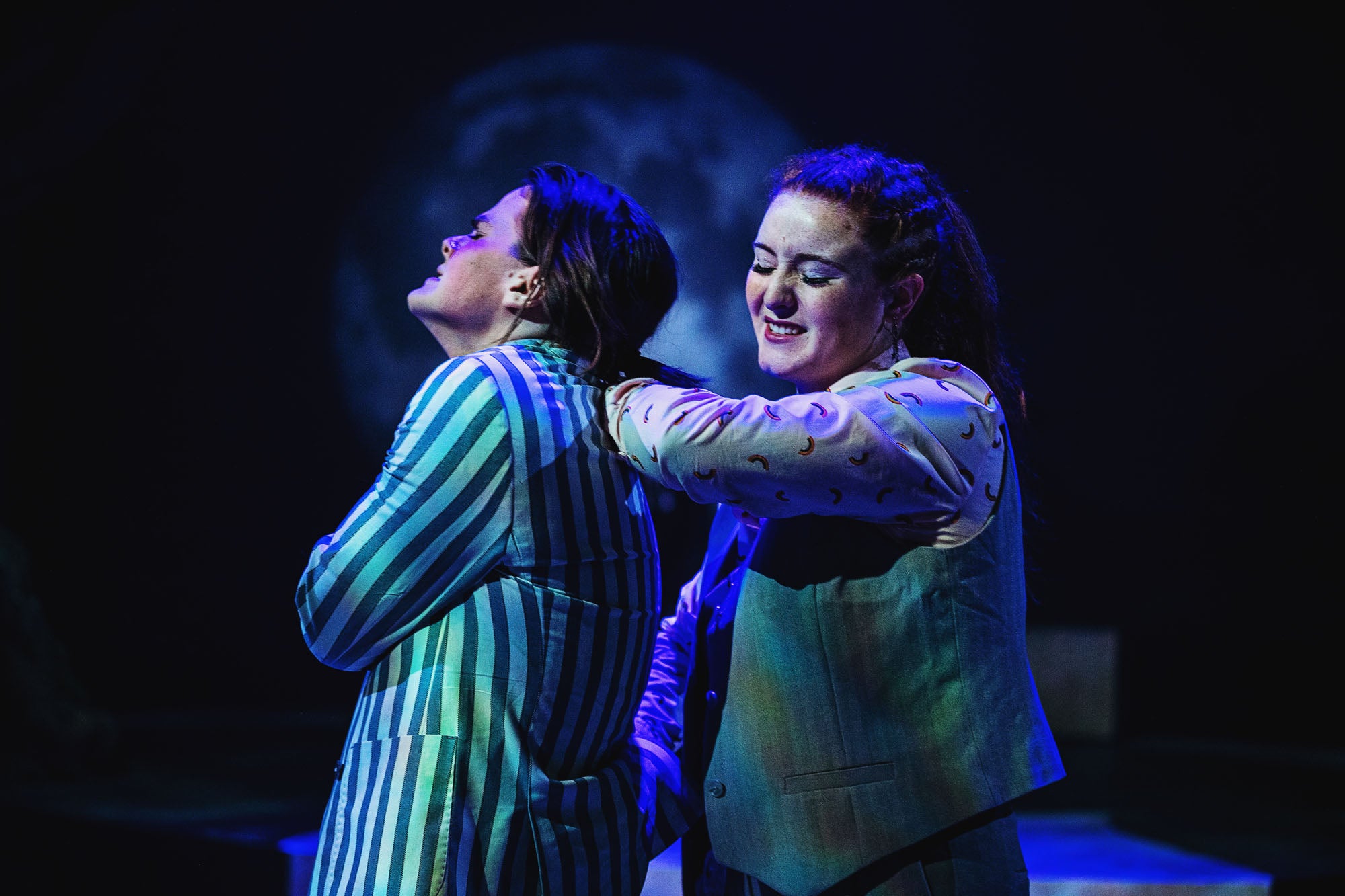 Lysandra (Sarah Kelly) twists the arm of Demetrius (Ethan Warren) in a crime of passion.