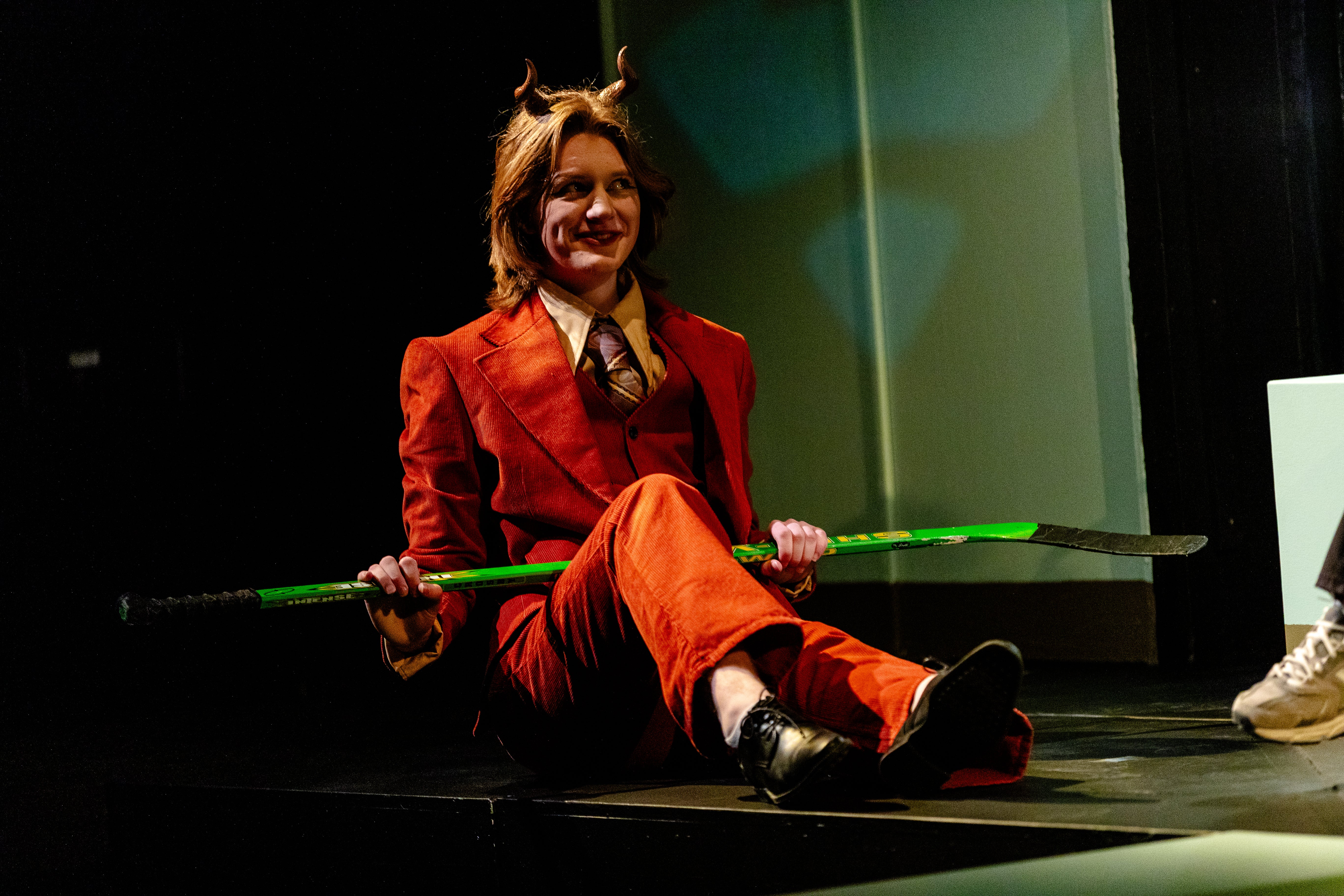 Smiling Duke sitting with a hockey stick
