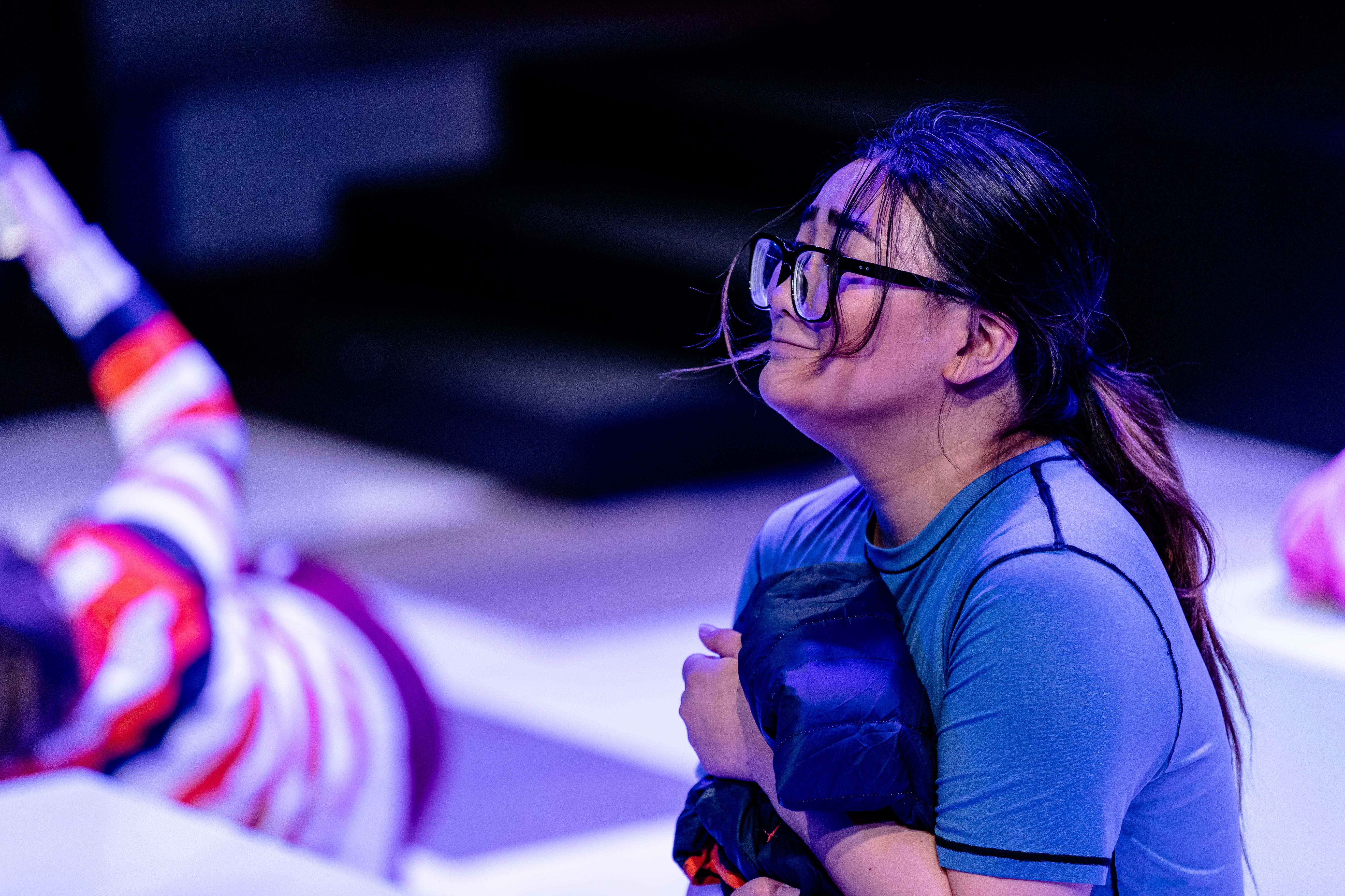 Aamir kneeling, looking off-camera at Tee