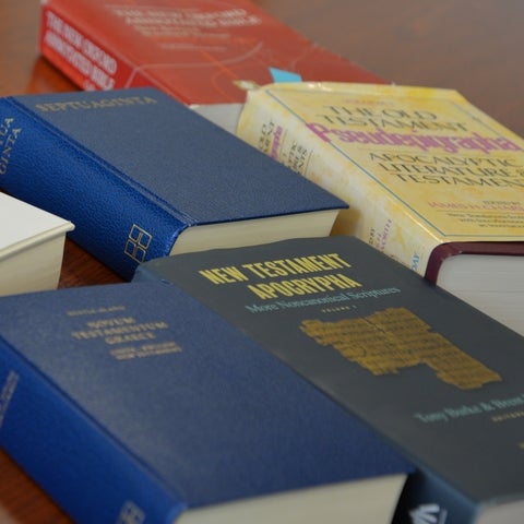 Several theology textbooks laying side-by-side on a table