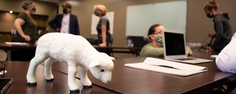 Ceramic lamb on classroom desk