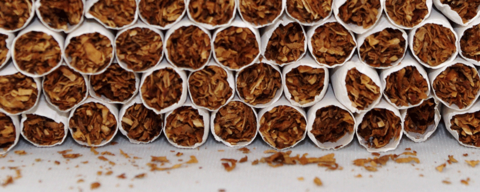 Close up of cigarette pile, showing tobacco.