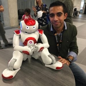 Marco Moran-Ledesma with a robot