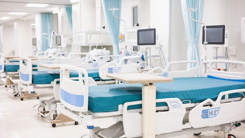 Empty hospital bed in a hospital ward