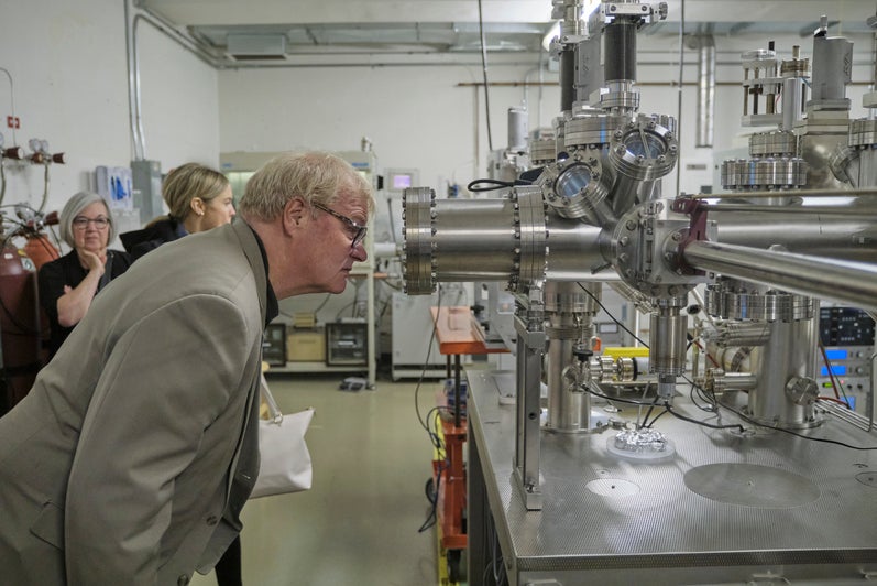 A person looking through an equipment. 