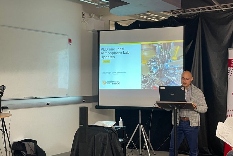 A person giving a presentation at the front of the room.