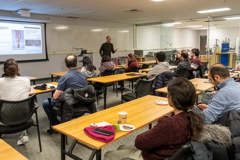 A person giving a presentation to a room full of people. 