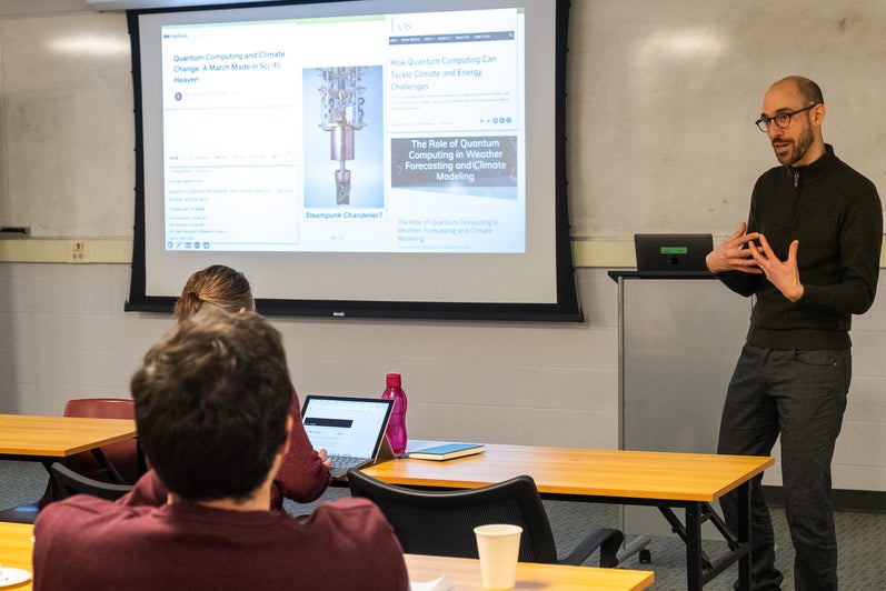 A person giving a presentation to a room full of people. 