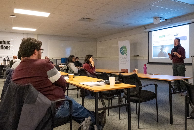 A person giving a presentation to a room full of people. 