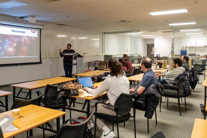 A person giving a presentation to a room full of people. 