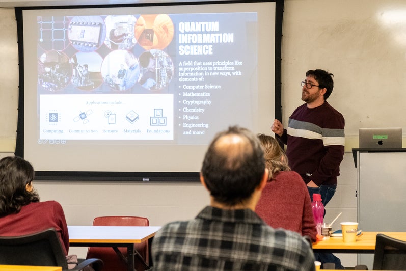 A person giving a presentation to a room full of people. 
