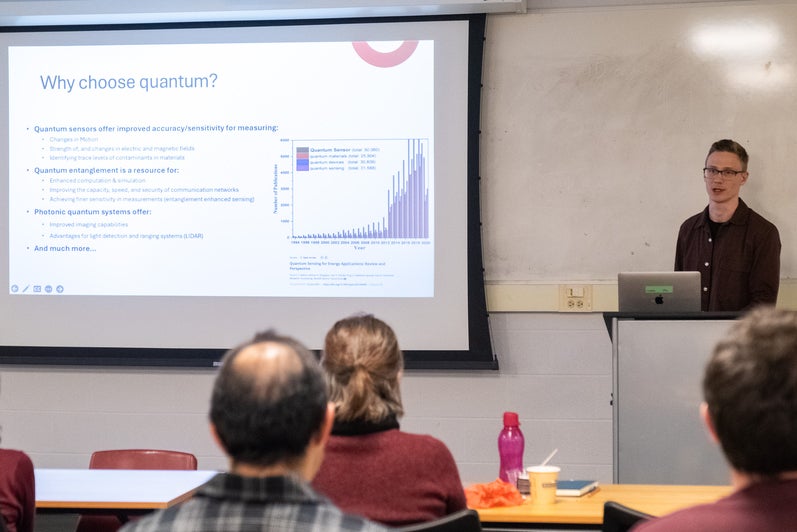 A person giving a presentation to a room full of people. 
