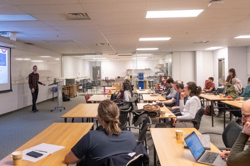 A person giving a presentation to a room full of people. 