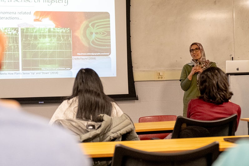 A person giving a presentation to a room full of people. 