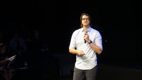 Connor Kapahi speaking into a microphone.