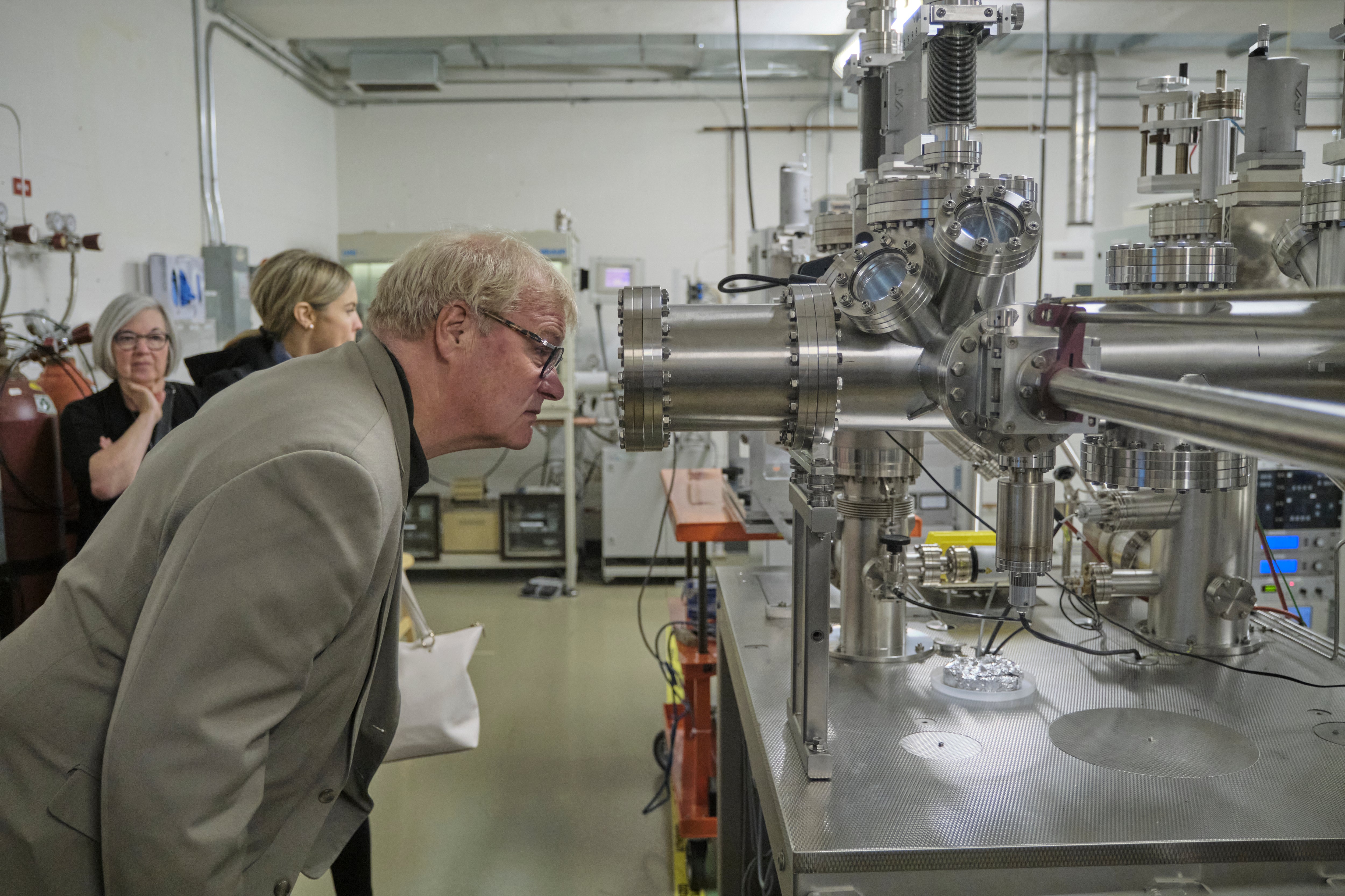 A person looking through an equipment. 