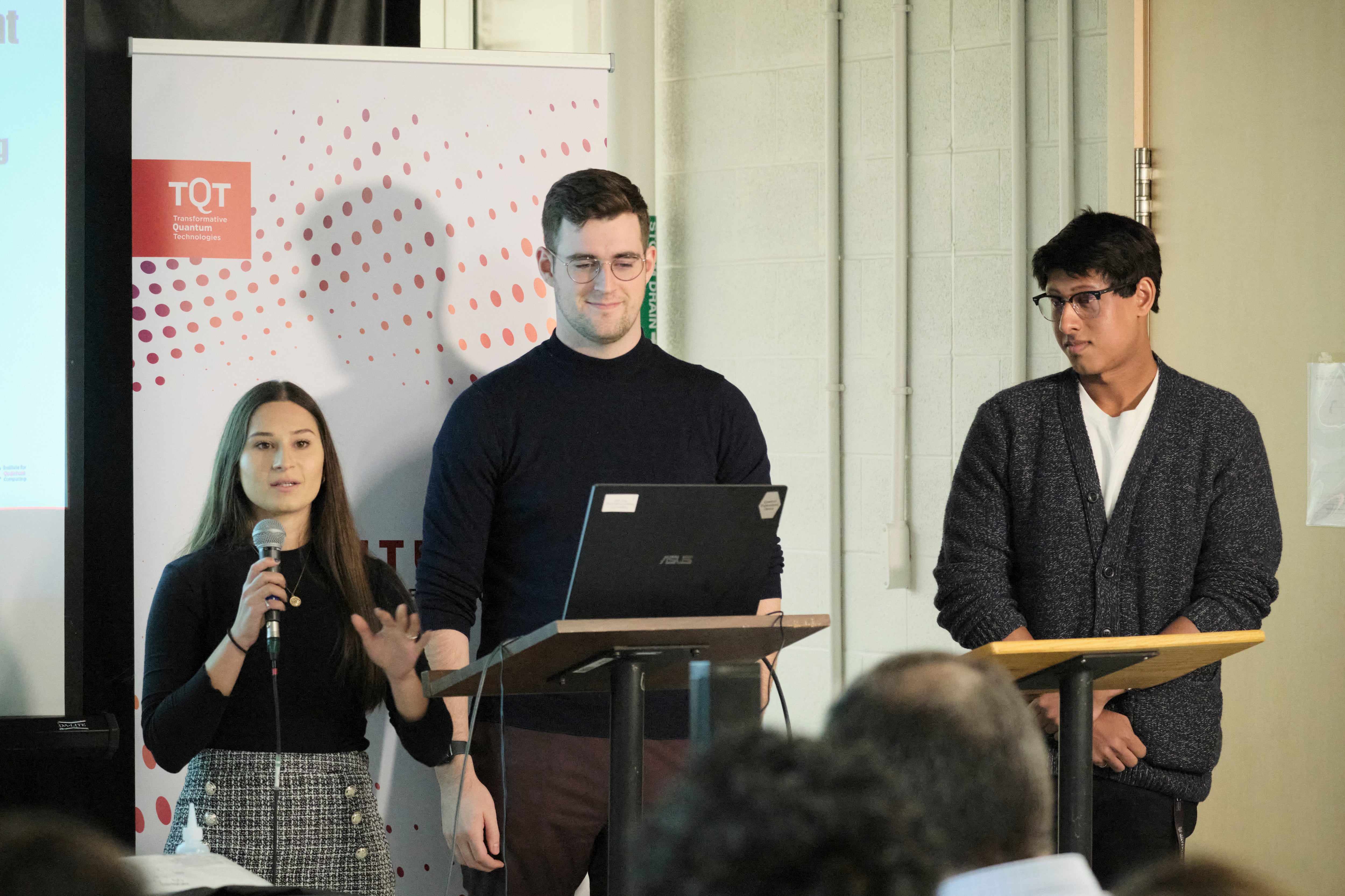 A group of people giving a presentation in front of a projector. 