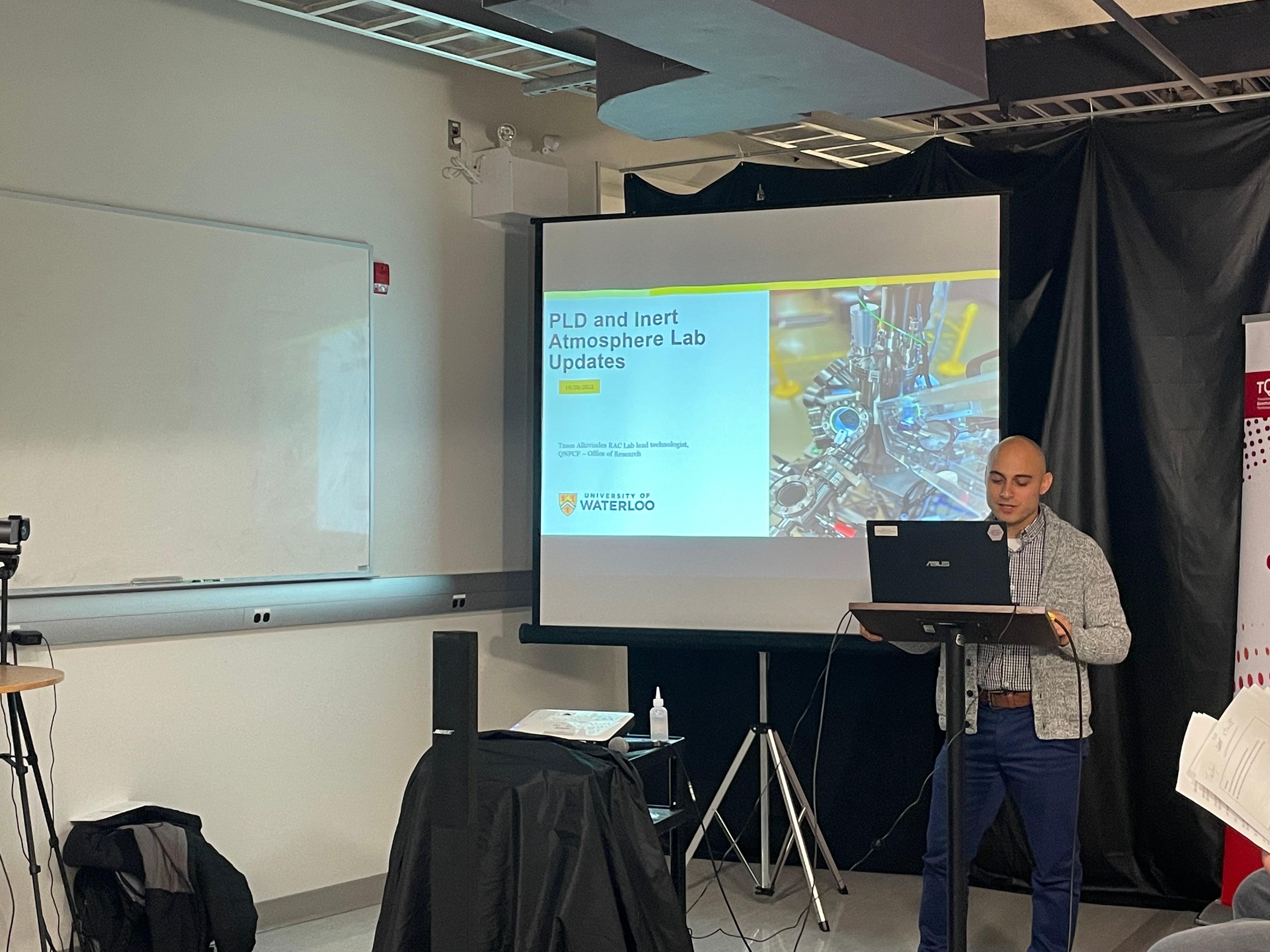 A person giving a presentation at the front of the room.