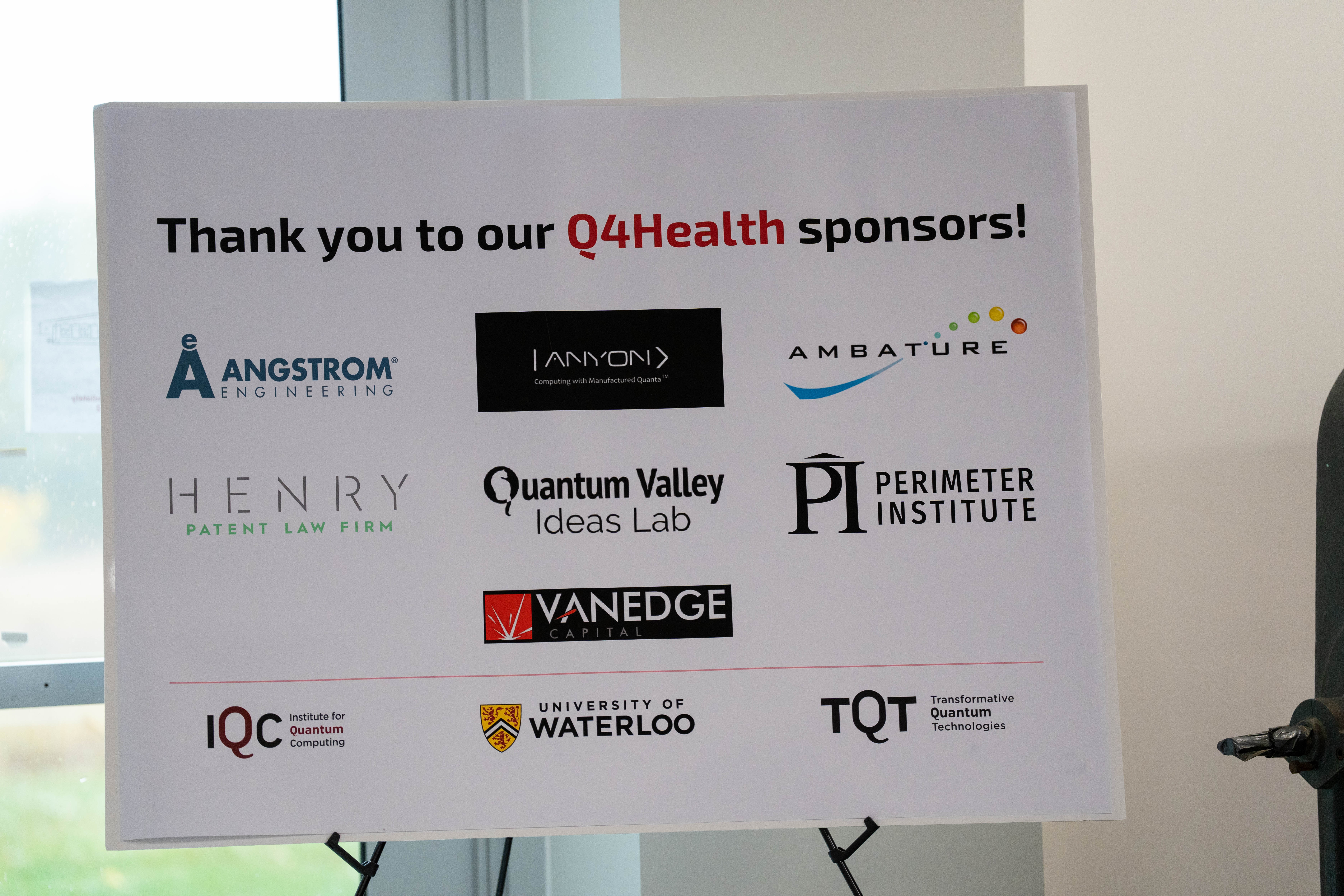 A variety of sponsor logos on a white foam board. 