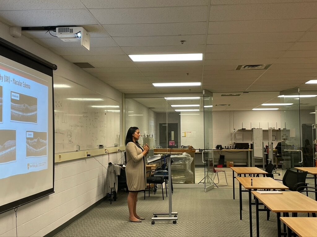 A person giving a presentation at the front of the room.
