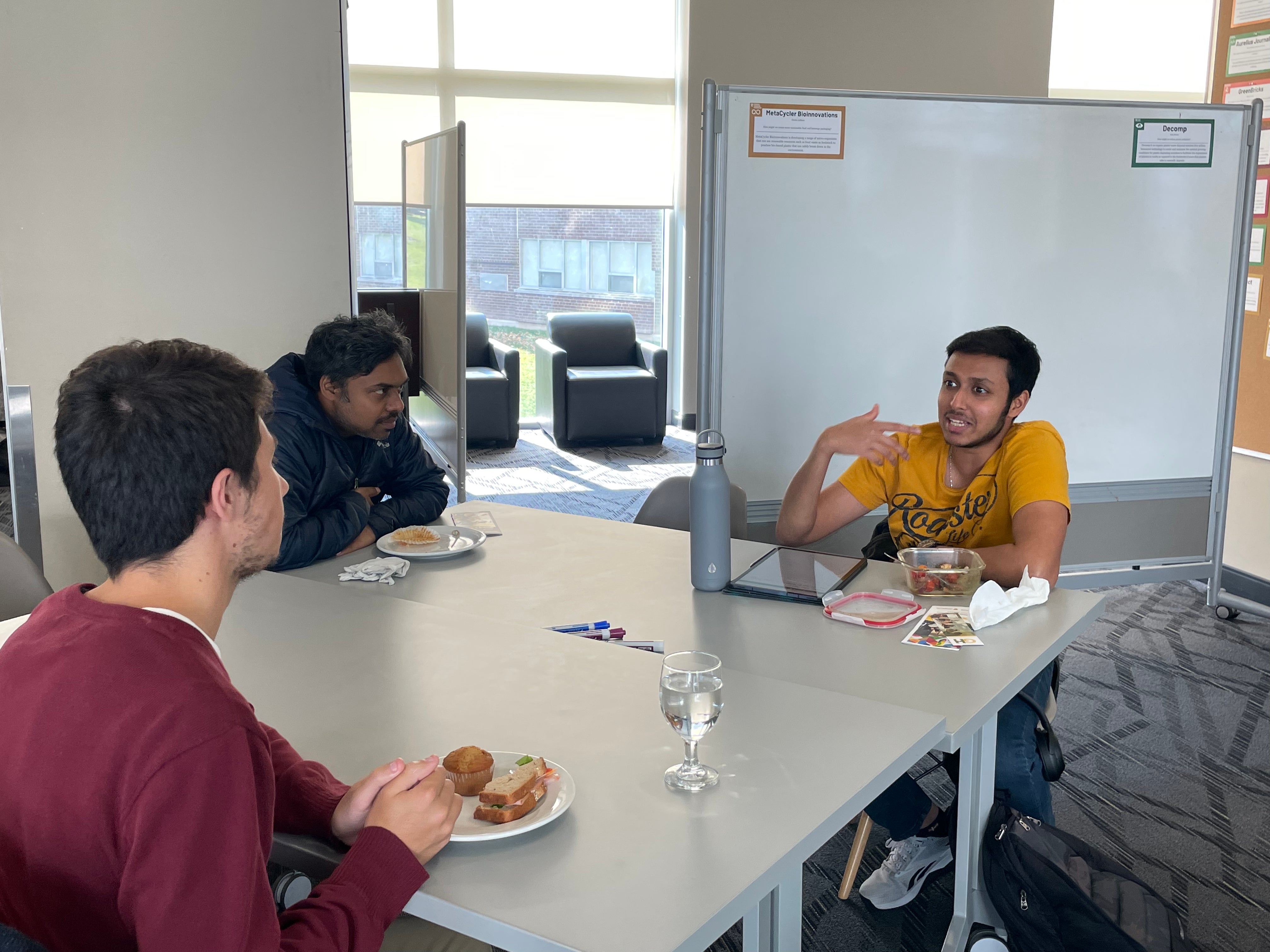 A group of people having a discussion at a table. 