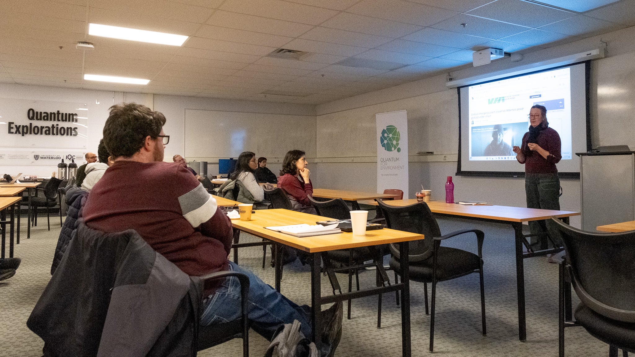 A person giving a presentation to a room full of people. 