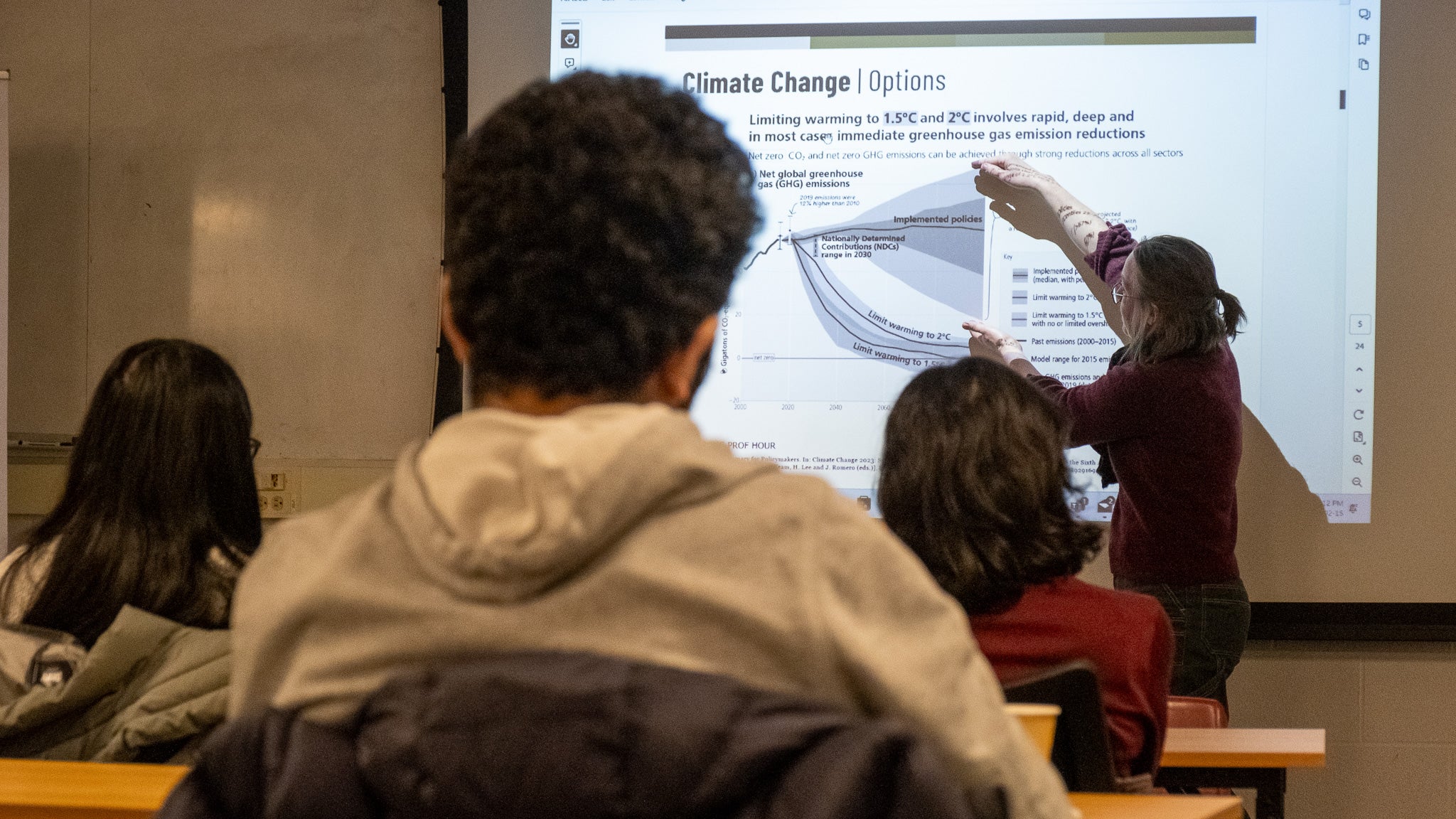 A person giving a presentation to a room full of people. 